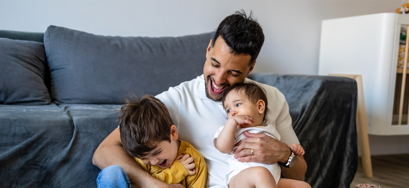 father and kids hugging